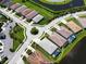 Aerial view showing the home backing onto a lake, and nearby community amenities like a pool and tennis courts at 5533 Long Shore Loop, Sarasota, FL 34238