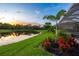 Lush backyard with a pond view and vibrant landscaping, showcasing Florida's natural beauty at 5533 Long Shore Loop, Sarasota, FL 34238