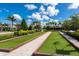 Scenic bocce ball court with artificial turf, bordered by manicured landscaping, and park benches at 5533 Long Shore Loop, Sarasota, FL 34238