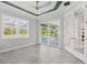 Bright bonus room featuring sliding doors to pool area, neutral walls, ceiling fan, and stylish, gray tile floors at 5533 Long Shore Loop, Sarasota, FL 34238