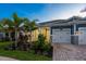 Inviting home exterior with a paver driveway, manicured landscaping, and a charming front entrance at 5533 Long Shore Loop, Sarasota, FL 34238