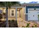 Cozy front porch showcasing a decorative front door, column supports, and paver walkway at 5533 Long Shore Loop, Sarasota, FL 34238