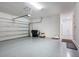 Clean, spacious garage with epoxy flooring, an automatic door, and ample storage space at 5533 Long Shore Loop, Sarasota, FL 34238
