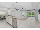 Kitchen with a large island, stainless steel appliances, granite counter tops and sliding glass doors at 5533 Long Shore Loop, Sarasota, FL 34238