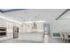 Spacious kitchen featuring a large island with seating, stainless steel appliances, and white cabinetry at 5533 Long Shore Loop, Sarasota, FL 34238