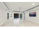 Spacious living space with tile floors and multiple access points to the covered patio and pool area at 5533 Long Shore Loop, Sarasota, FL 34238