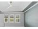 Bright bedroom featuring large windows, neutral paint, tray ceilings and a modern ceiling fan at 5533 Long Shore Loop, Sarasota, FL 34238