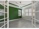 Well-lit office with French doors, shuttered windows, and a modern ceiling fan at 5533 Long Shore Loop, Sarasota, FL 34238