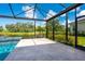 Screened-in patio with pool and serene lake view, offering a relaxing outdoor retreat at 5533 Long Shore Loop, Sarasota, FL 34238