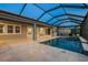 View of the lanai's large screened pool, tiled deck, and patio doors for seamless indoor/outdoor living at 5533 Long Shore Loop, Sarasota, FL 34238