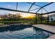 Gorgeous screened pool with water feature overlooking tranquil pond and green space at 5533 Long Shore Loop, Sarasota, FL 34238