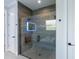 Modern walk-in shower with a built-in bench, rainfall showerhead, and glass enclosure at 5533 Long Shore Loop, Sarasota, FL 34238