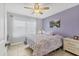 Comfortable bedroom with a floral-patterned quilt, white furniture, and ample natural light at 5891 Welcome Rd # I6, Bradenton, FL 34207