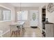 Bright dining room with a modern table set and white chairs, adjacent to the kitchen at 5891 Welcome Rd # I6, Bradenton, FL 34207
