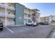 Low angle exterior of a condo building with parking spaces and second story apartments at 5891 Welcome Rd # I6, Bradenton, FL 34207