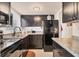 A well-lit kitchen featuring dark cabinets and stainless steel appliances at 5891 Welcome Rd # I6, Bradenton, FL 34207