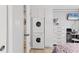 Convenient laundry closet with stacked washer and dryer, adjacent to a bedroom area at 5891 Welcome Rd # I6, Bradenton, FL 34207
