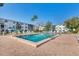 Sparkling community pool surrounded by lounge chairs and lush greenery at 5891 Welcome Rd # I6, Bradenton, FL 34207
