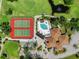 Aerial view of community amenities: pool, tennis courts, clubhouse, pond, and mature trees at 6061 Fairway Ln # 1411, Bradenton, FL 34210