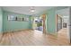 Sunlit bedroom with hardwood floors, floral curtains, and sliding glass doors to lanai at 6061 Fairway Ln # 1411, Bradenton, FL 34210