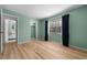 Spacious bedroom with a window, light hardwood floors, and a closet at 6061 Fairway Ln # 1411, Bradenton, FL 34210