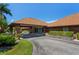 Community clubhouse entrance with well-manicured landscaping and convenient circular driveway at 6061 Fairway Ln # 1411, Bradenton, FL 34210