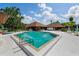 Large community pool with ample seating and umbrellas; a relaxing oasis at 6061 Fairway Ln # 1411, Bradenton, FL 34210