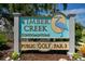 Timber Creek Condominiums sign with a blue heron and Public Golf Par 3 information, set amongst lush foliage at 6061 Fairway Ln # 1411, Bradenton, FL 34210