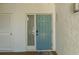 Inviting front door with textured wall, welcome mat, and adjacent storage area at 6061 Fairway Ln # 1411, Bradenton, FL 34210