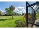 Relaxing screened lanai with golf course views and tropical landscaping at 6061 Fairway Ln # 1411, Bradenton, FL 34210