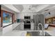 Bright kitchen features stainless steel appliances, marble countertops and a view of the pool at 6061 Fairway Ln # 1411, Bradenton, FL 34210