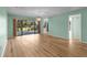 Bright, open living area with wood floors and sliding glass doors to the screened lanai at 6061 Fairway Ln # 1411, Bradenton, FL 34210