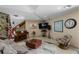 Relaxing living room with a stone fireplace, piano, and comfortable seating area at 6061 Fairway Ln # 1411, Bradenton, FL 34210