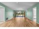 Spacious living area with wood floors, light green walls, and screened patio view at 6061 Fairway Ln # 1411, Bradenton, FL 34210