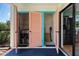 Outdoor patio includes laundry closet with pink doors and view of tropical landscaping at 6061 Fairway Ln # 1411, Bradenton, FL 34210