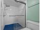 Modern bathroom featuring a glass-enclosed tiled shower with blue shower floor at 6061 Fairway Ln # 1411, Bradenton, FL 34210