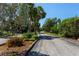Neighborhood street view lined with mature trees and lush landscaping at 6061 Fairway Ln # 1411, Bradenton, FL 34210