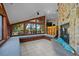 Bright sun room with a stone fireplace, cozy seating and scenic views at 6061 Fairway Ln # 1411, Bradenton, FL 34210