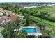 Aerial view of a pool area with lounge chairs, surrounded by mature trees at 6111 Courtside Dr # 61, Bradenton, FL 34210