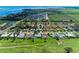 Aerial view of a neighborhood with lush greenery with the house marked by a circle at 6111 Courtside Dr # 61, Bradenton, FL 34210