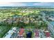 Aerial view of a neighborhood with lush greenery and a golf course with the house marked by a circle at 6111 Courtside Dr # 61, Bradenton, FL 34210