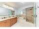 Beautiful bathroom featuring double sink vanity, shower with glass door, and soaking tub at 6111 Courtside Dr # 61, Bradenton, FL 34210