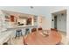 Dining area next to a bright, open kitchen featuring stainless steel appliances and wood cabinets at 6111 Courtside Dr # 61, Bradenton, FL 34210
