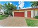 Front exterior of the home with a spacious driveway, a garage, and well-manicured lawn at 6111 Courtside Dr # 61, Bradenton, FL 34210
