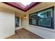 Well-lit front entry featuring a solid door with glass panel and a wooden porch at 6111 Courtside Dr # 61, Bradenton, FL 34210