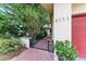Inviting front entrance with a brick walkway, a wrought iron gate and lush landscaping at 6111 Courtside Dr # 61, Bradenton, FL 34210