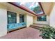 Cozy brick-paved front porch with comfortable seating, perfect for relaxing at 6111 Courtside Dr # 61, Bradenton, FL 34210