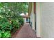 Charming front walkway lined with lush plants leading to the front of the home at 6111 Courtside Dr # 61, Bradenton, FL 34210