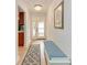 Inviting hallway with a bench, stylish lighting, and a view of the front door at 6111 Courtside Dr # 61, Bradenton, FL 34210