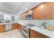 Well-equipped kitchen with stainless steel appliances, quartz countertops, and wood cabinets at 6111 Courtside Dr # 61, Bradenton, FL 34210